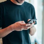 man on his smart phone betting